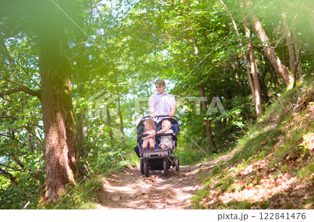 Father with children in all terrain stroller Father with children in all terrain stroller 122841476