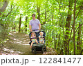 Father with children in all terrain stroller 122841477