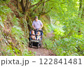 Father with children in all terrain stroller 122841481