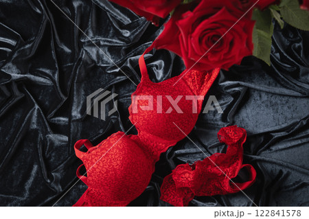 Lace women's red underwear, lingerie and red roses for Valentine's day on dark. Romantic dating. View from above. Copy space. Lace women's red underwear, lingerie and red roses for Valentine's day on dark. Romantic dating. View from above. Copy space. 122841578