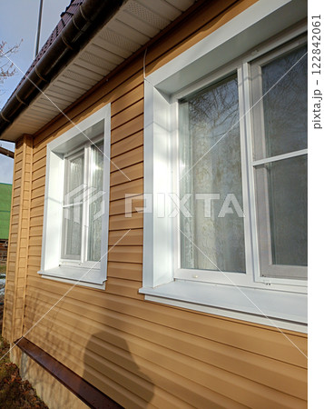 Windows on the first floor of a rural house on a sunny winter day 122842061
