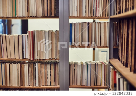 Many book shelves in a library 122842335