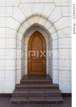 wooden door on the street in the mosque in the wall of marble 122842341