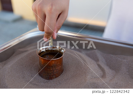 Coffee is made on the sand. Coffee is made on the street for tourists on the sand. 122842342