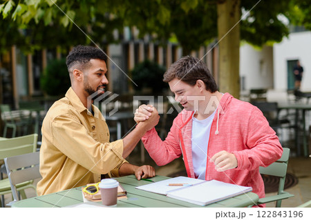 Young man with Down syndrome greeting his special educator teacher. 122843196