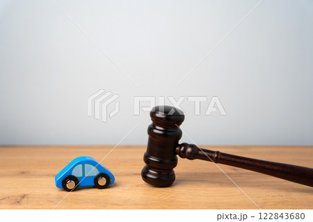 Judge's hammer and toy blue car. Traffic and driving rules concept. Auto accident, drunk driving, court of law, justice Judge's hammer and toy blue car. Traffic and driving rules concept. Auto accident, drunk driving, court of law, justice 122843680