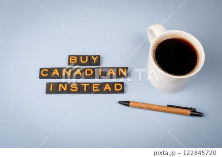 Buy Canadian Insead. Text from old alphabet letters. Coffee mug on the table Buy Canadian Insead. Text from old alphabet letters. Coffee mug on the table 122845720