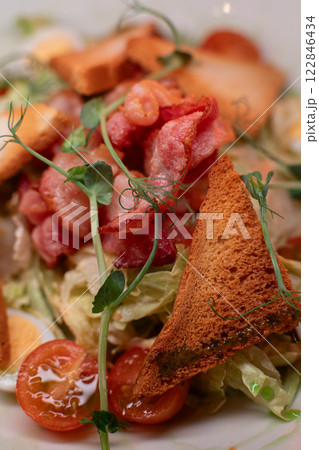 Caesar salad with bacon is mouthwatering and Caesar salad with bacon is mouthwatering and 122846434
