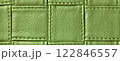 Texture green leather background with square pattern and stitch, macro. Abstract olive backdrop from textile 122846557