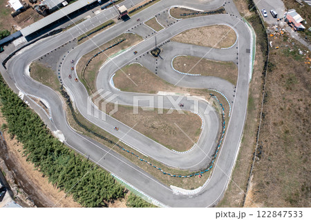 Distant drone capturing go-karts on winding tracks Distant drone capturing go-karts on winding tracks 122847533