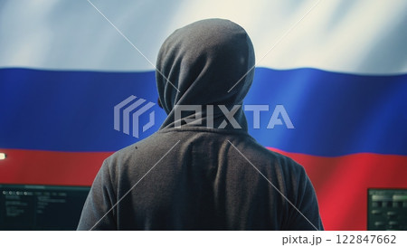Expert in governmental hacking room with a Russian flag on big screen, individual in cyberwarfare and propaganda. Russian federation hacker works on sabotage and political manipulation. Camera B. 122847662