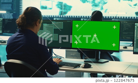 Governmental hackers using green screen in performing cyber security monitoring and threat detection. Examining network security and protection against cyber attacks, national intelligence. Camera A. 122847675