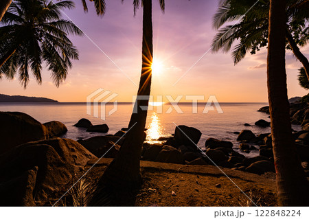 Silhouette coconut palm trees at sunset or sunrise sky over sea, Amazing colorful light sky nature landscape, Beautiful nature sky and clouds background Silhouette coconut palm trees at sunset or sunrise sky over sea, Amazing colorful light sky nature landscape, Beautiful nature sky and clouds background 122848224