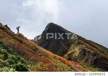 秋の谷川岳　稜線で写真を撮る登山者 122849221