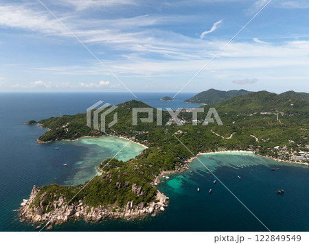 A panoramic view of a tropical coastline with lush green hills and turquoise water. Shark Bay. Koh Tao, Thailand. A panoramic view of a tropical coastline with lush green hills and turquoise water. Shark Bay. Koh Tao, Thailand. 122849549