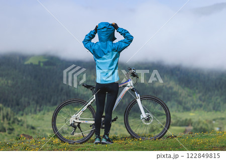 Woman riding mountain bike in forest mountain top Woman riding mountain bike in forest mountain top 122849815