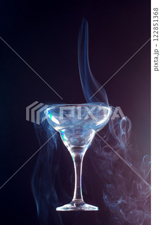 levitating glass full of smoke on a black background 122851368