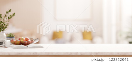 A luxury white tabletop with decorative items over a blurred background of a modern living room. 122852041