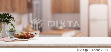 A close-up of a kitchen countertop with a blurred background of a contemporary Scandinavian kitchen. 122852054