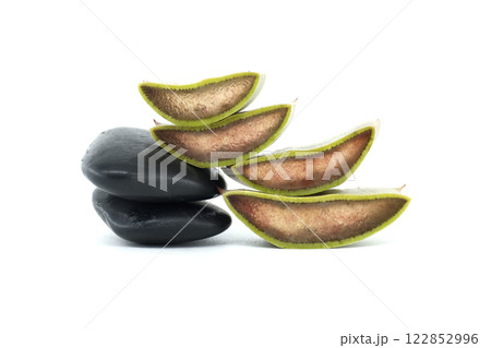 Close-Up of Fresh Aloe Vera Slices with Black Smooth Stones 122852996
