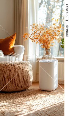 cozy living room with white air purifier, knitted pouf, and floral decor 122853034