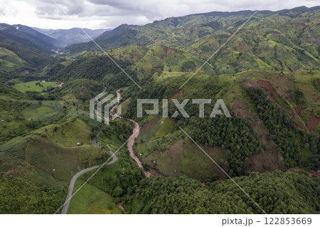 Landscape of Morning Mist with Mountain Layer. mountain ridge and clouds in rural jungle bush forest 122853669