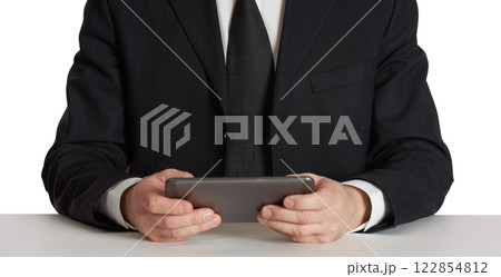 Businessman trader in a black suit with a tablet. 122854812