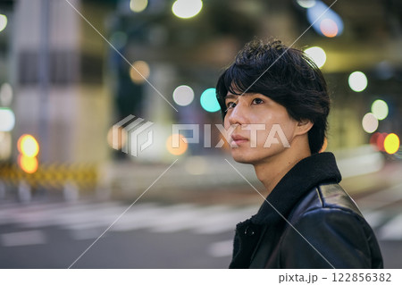 夜の街を歩く若い男性の顔のクローズアップ 夜の街を歩く若い男性の顔のクローズアップ 122856382