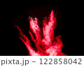 Red cloud of dust is blowing on white backdrop. The dust is red and black in color. 122858042