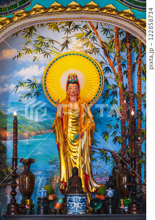 An altar with a Buddhist god inside a pagoda on the marble mountains of Da Nang. 122858734