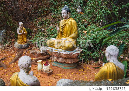 Buddha sculptures in the garden at the pagoda in the marble mountains of Da Nang. 122858735