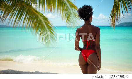 Tropical Paradise Serenity Captured in Red Swimwear Against Turquoise Caribbean Waters 122859021