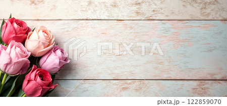 Delicate Pink and Coral Roses Against Rustic Whitewashed Wood Creating Romantic Backdrop 122859070