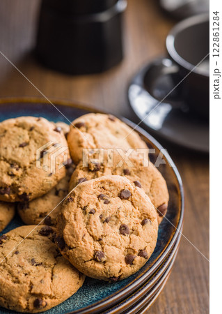 Chocolate chip cookies on plate on wooden table. Chocolate chip cookies on plate on wooden table. 122861284