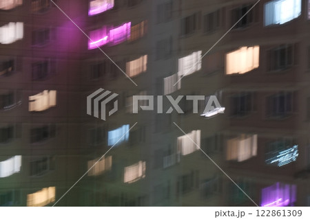 Blurred city lights at night, simulating vision with astigmatism. Abstract urban atmosphere with glowing bokeh effec Blurred city lights at night, simulating vision with astigmatism. Abstract urban atmosphere with glowing bokeh effec 122861309