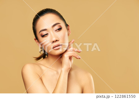 Beauty portrait of young woman with healthy skin and natural makeup looking on copy space Beauty portrait of young woman with healthy skin and natural makeup looking on copy space 122861550