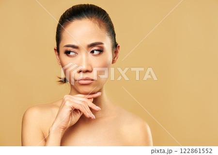 Thoughtful confused woman thinking and looking aside on copy space Thoughtful confused woman thinking and looking aside on copy space 122861552