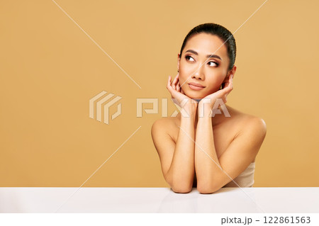 Beautiful smiling woman portrait looking aside on copy space 122861563