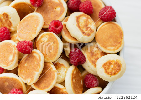 Delicious freshly cooked Homemade Mini Pancake with raspberries. Trendy food. Top view. breakfast food for kids. Delicious freshly cooked Homemade Mini Pancake with raspberries. Trendy food. Top view. breakfast food for kids. 122862124