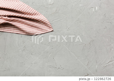 top view with red empty kitchen napkin isolated on table background. Folded cloth for mockup with copy space, Flat lay. Minimal style 122862726