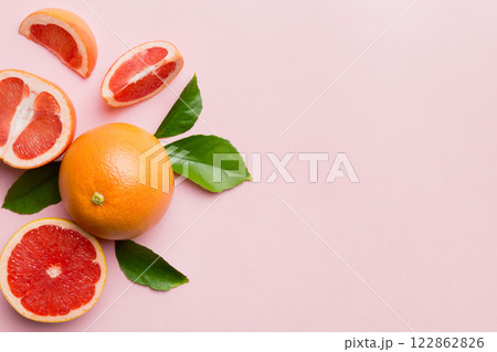 fresh Fruit grapefruit with Juicy grapefruit slices on colored background. Top view. Copy Space. creative summer concept. Half of citrus in minimal flat lay with copy space 122862826