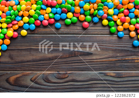 Mixed collection of colorful candy, on colored background. Flat lay, top view. frame of colorful chocolate coated candy Mixed collection of colorful candy, on colored background. Flat lay, top view. frame of colorful chocolate coated candy 122862872