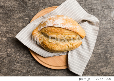 Freshly baked bread on cutting board against white wooden background. top view bread with copy space 122862900