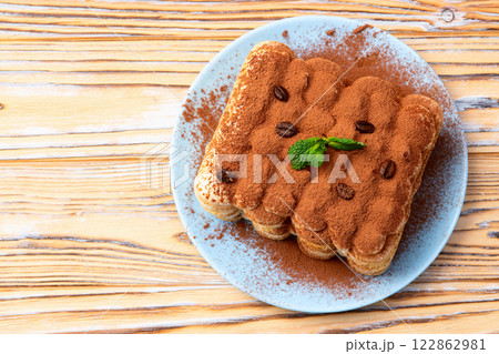 Classic Tiramisu Dessert on Rustic Plate Classic Tiramisu Dessert on Rustic Plate 122862981