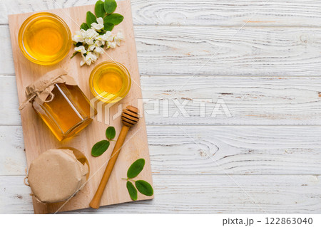 honey jar with acacia flowers and leaves. fresh honey top view flat lay 122863040