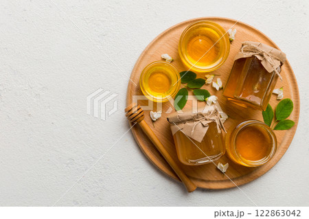 honey jar with acacia flowers and leaves. fresh honey top view flat lay honey jar with acacia flowers and leaves. fresh honey top view flat lay 122863042