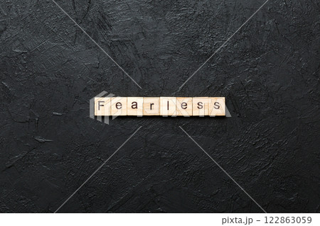 Fearless word written on wood block. Fearless text on cement table for your desing, concept 122863059