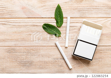 Pack of menthol cigarettes and fresh mint on colored table, Menthol cigarettes top view flat lay 122863254
