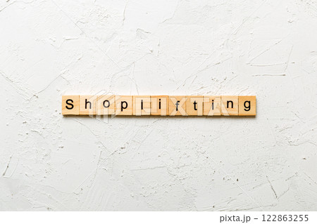 Shoplifting word written on wood block. Shoplifting text on cement table for your desing, Top view concept Shoplifting word written on wood block. Shoplifting text on cement table for your desing, Top view concept 122863255