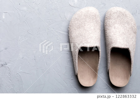 Warm winter women woolen slippers on the floor. Copy space for text Warm winter women woolen slippers on the floor. Copy space for text 122863332